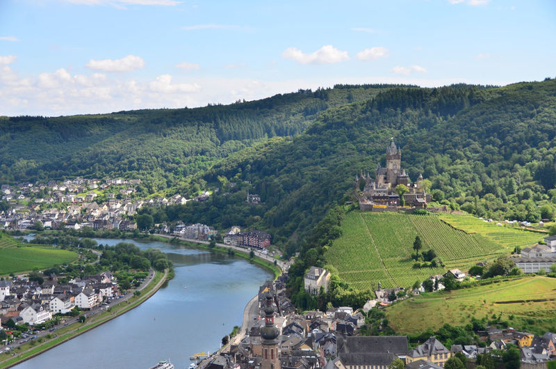 High angle view of cochem castle on hill by river in town