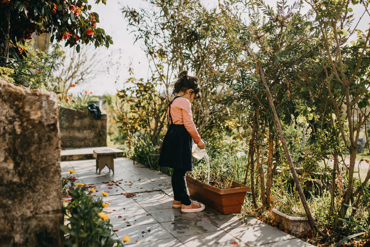 Cute girl watering plant