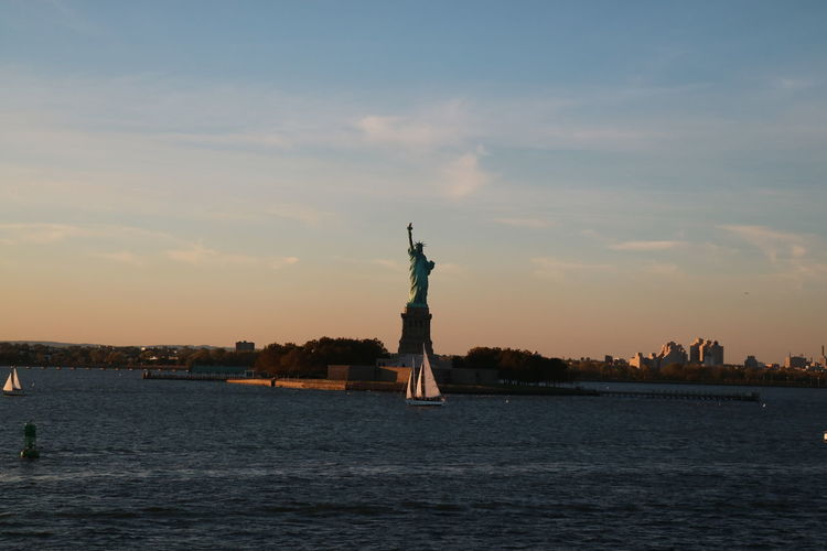 Statue of liberty with city in background