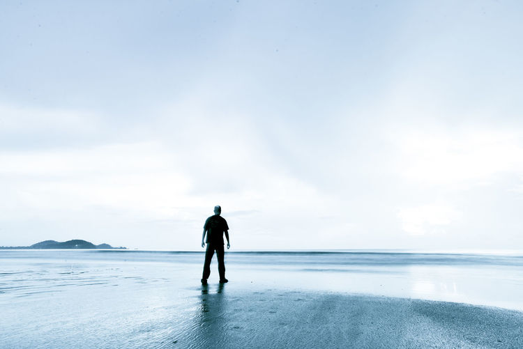 Silhouette of people standing on beach
