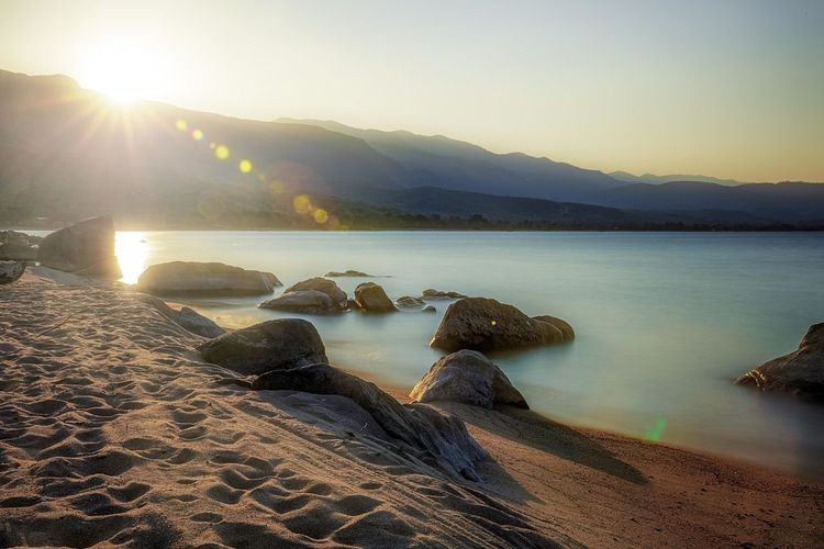 Scenic view of beach against sky during sunset