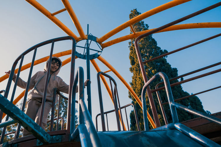 Low angle portrait of child having fun in playground