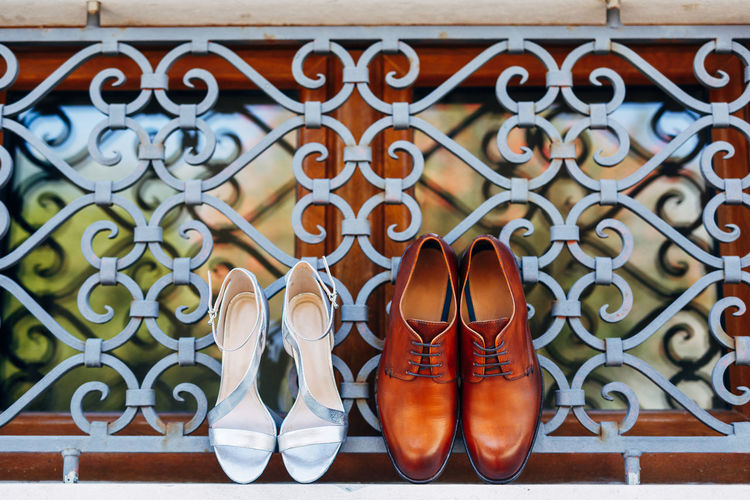 Close-up of shoes on railing