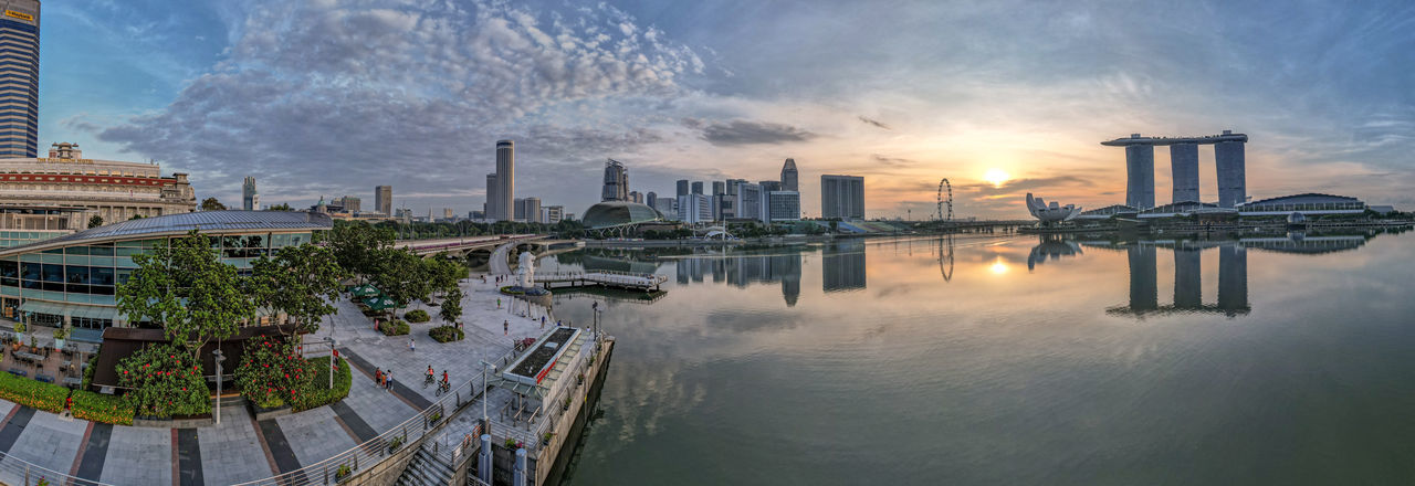 Panoramic view of buildings in city during sunrise at merlion park singapore with marina bay sands 