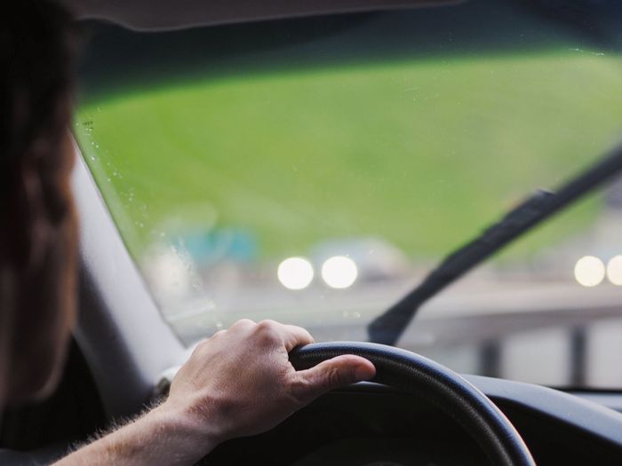 Cropped image of man driving car