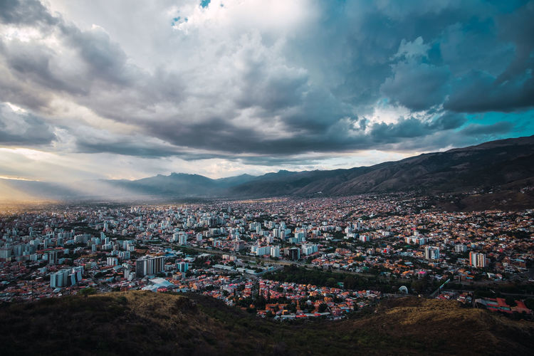 Areal view of cochabamba, bolivia with cloudy skys and rays of sunlight. located in south america