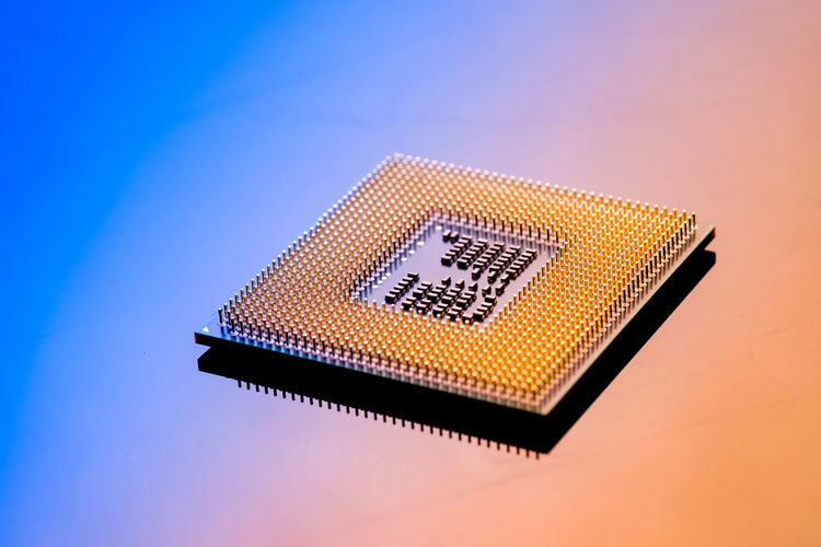 High angle view of computer chip on colored background