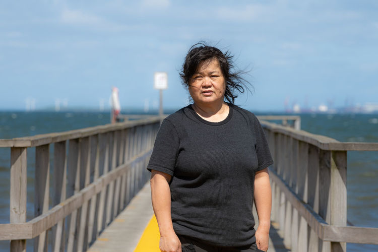 An asian middle aged woman on a jetty