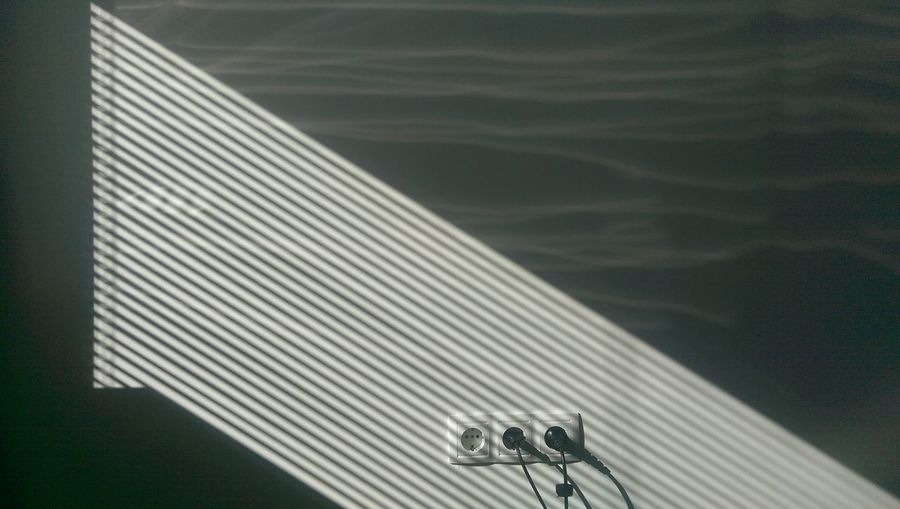 Low angle view of metal against wall