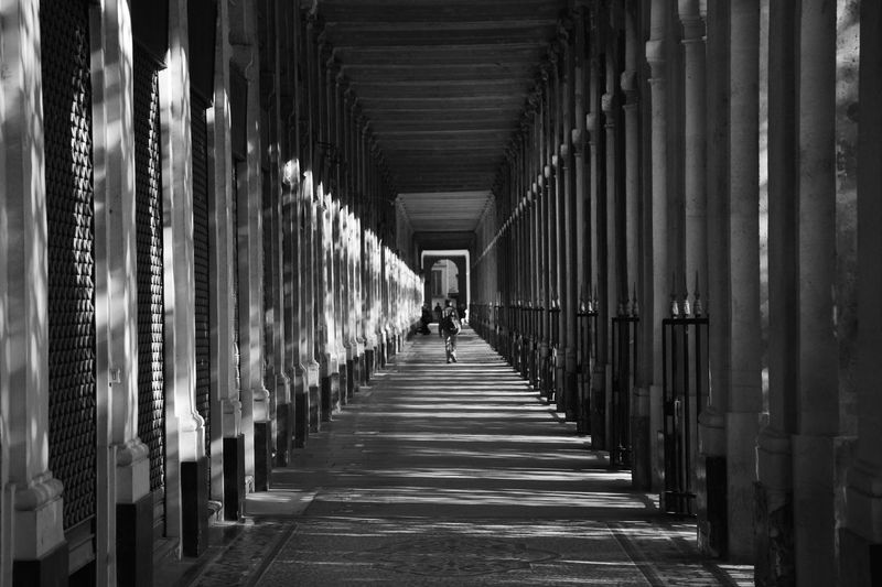 Rear view of woman walking in corridor of building