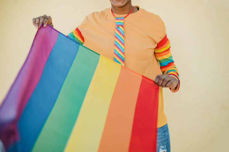 Black woman showing rainbow flag of lgbt community