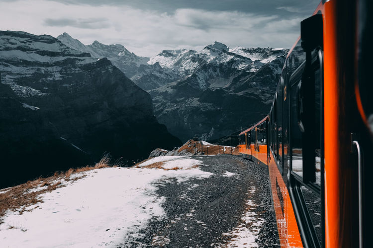 Train against snowcapped mountains