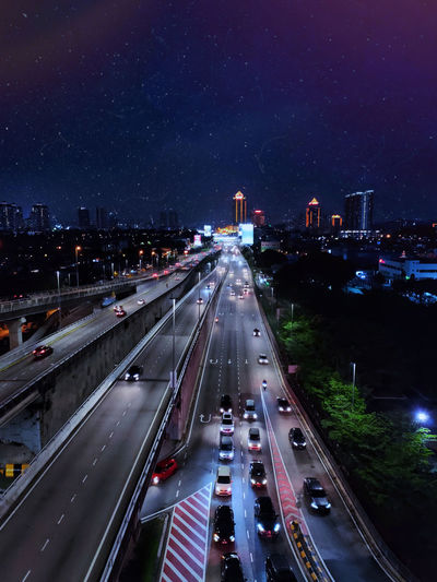 High angle view of highway in city at night