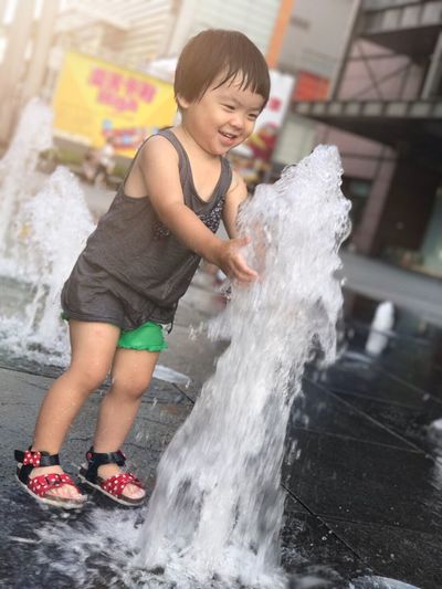 Full length of smiling boy in water