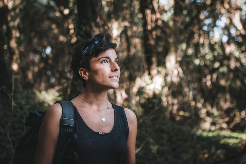 Smiling woman standing in forest