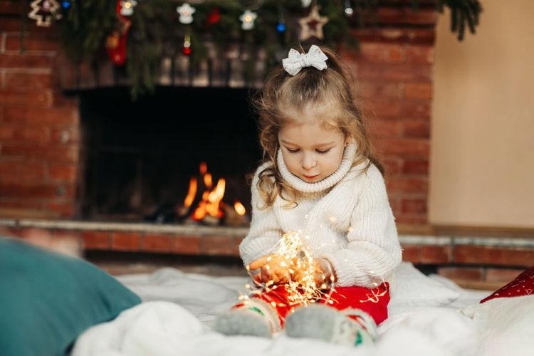 Portrait of girl playing with christmas tree