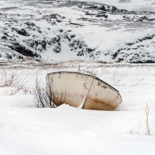 Abandoned boat on snow