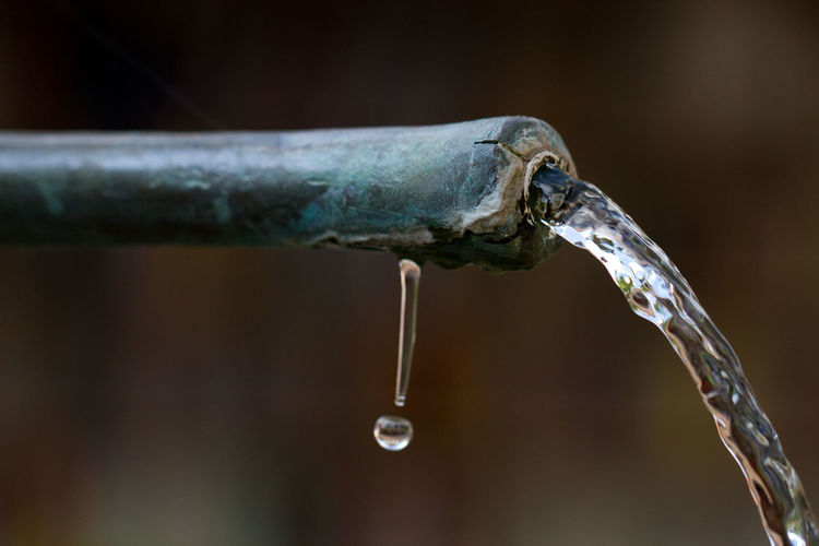 Close-up of water drop from pipe