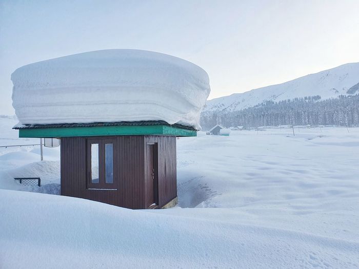 Built structure on snow covered mountain against sky, gulmarg kashmir 2021