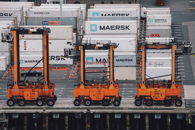 High angle view of forklift with containers at harbor
