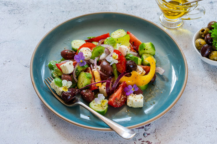 Traditional greek salad with fresh vegetables and feta cheese - healthy food idea