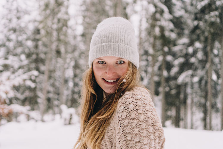 Portrait of smiling young woman in snow