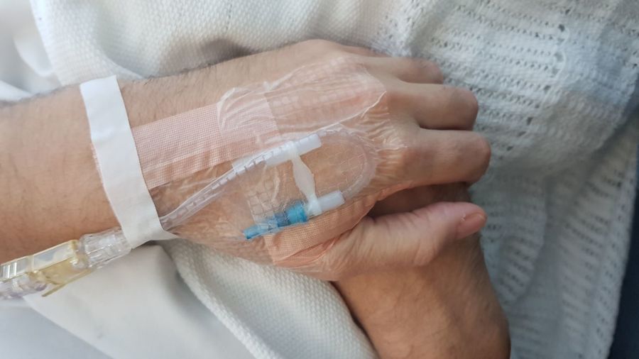 Close-up of patient hand with iv drip in hospital