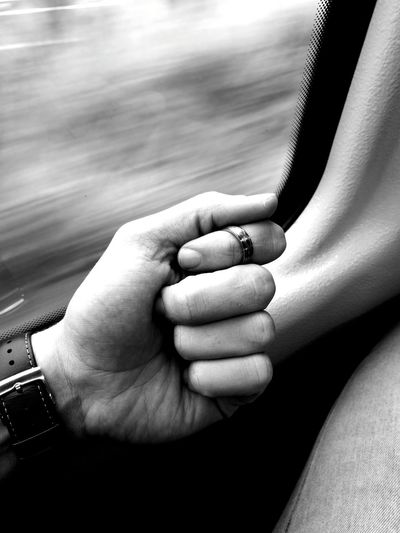 Cropped hand gesturing by window