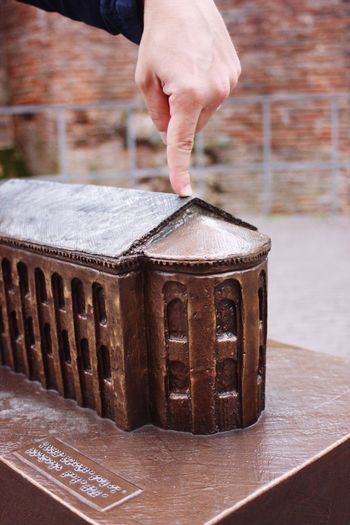 Cropped image of hand on model house