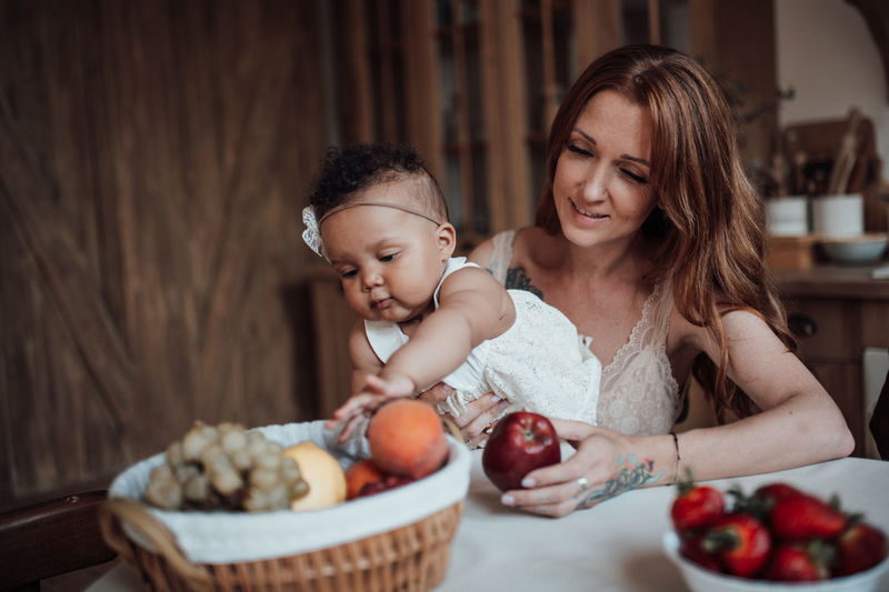 Mother and daughter with fruits