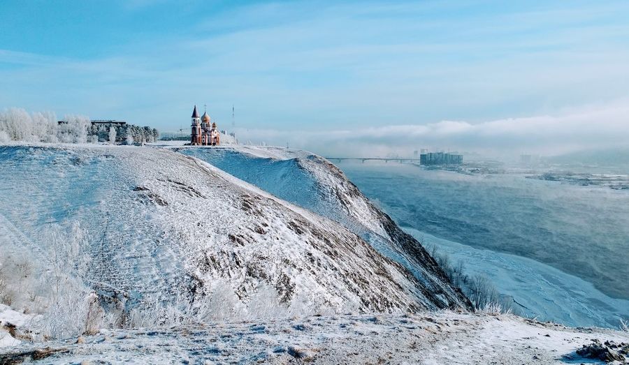 High angle view of cathedral on cliff against sky during winter