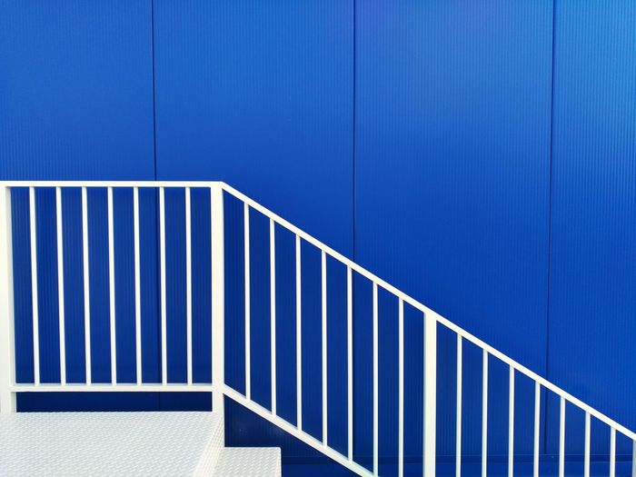 Close-up of metallic structure against blue wall