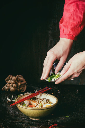Cropped hands of woman preparing food on table