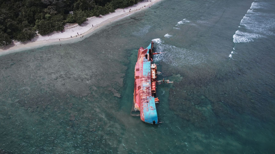 High angle view of nautical vessel on road by sea