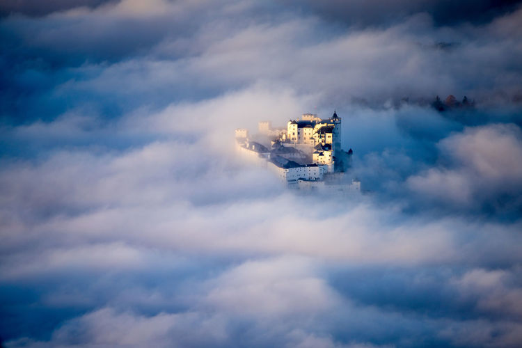 Fortress hohensalzburg rising above a sea of clouds, salzburg, austria