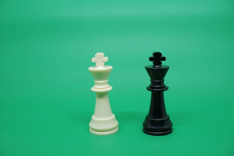 Close-up of chess pieces against green background