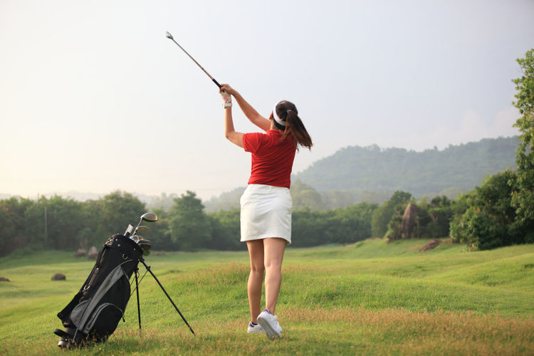 Full length of woman standing on golf course