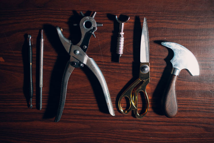 High angle view of work tools on wooden table