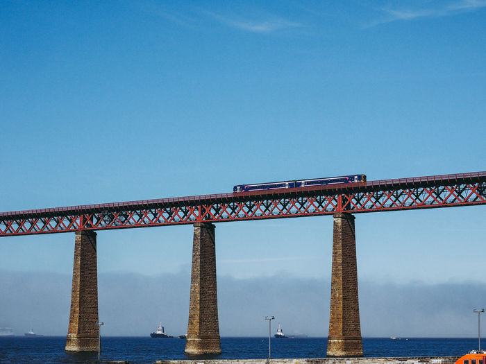 Railway bridge over sea against sky