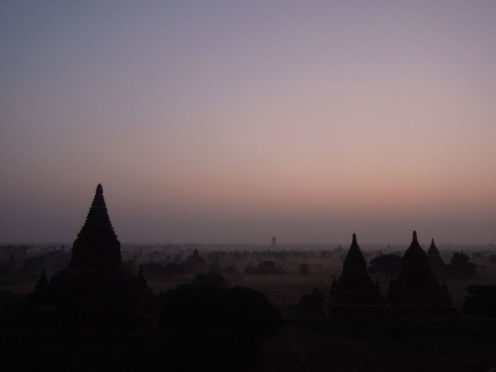 Silhouette temple against sky during sunrise
