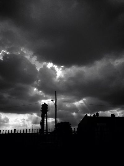 Silhouette of building against dramatic sky