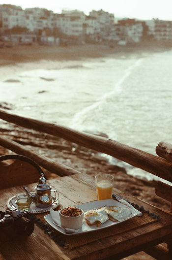 High angle view of breakfast on table against seashore