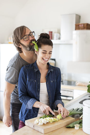 Playful couple in kitchen
