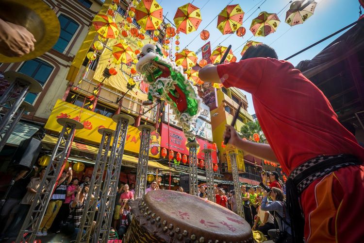 Low angle view of people enjoying lion dancing during chinese new year