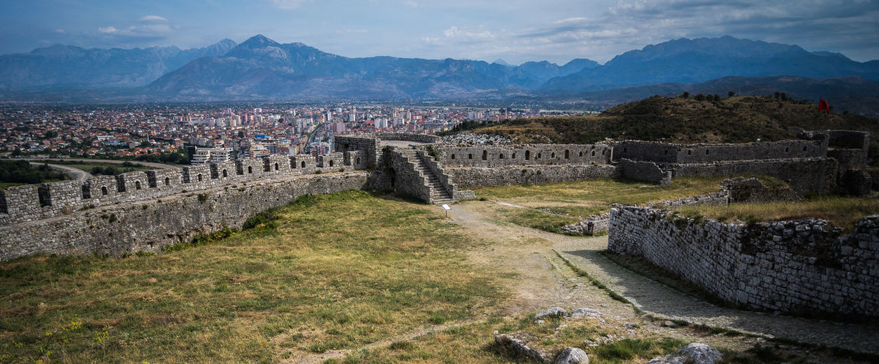High angle view of rozafa castle and cityscape against mountains
