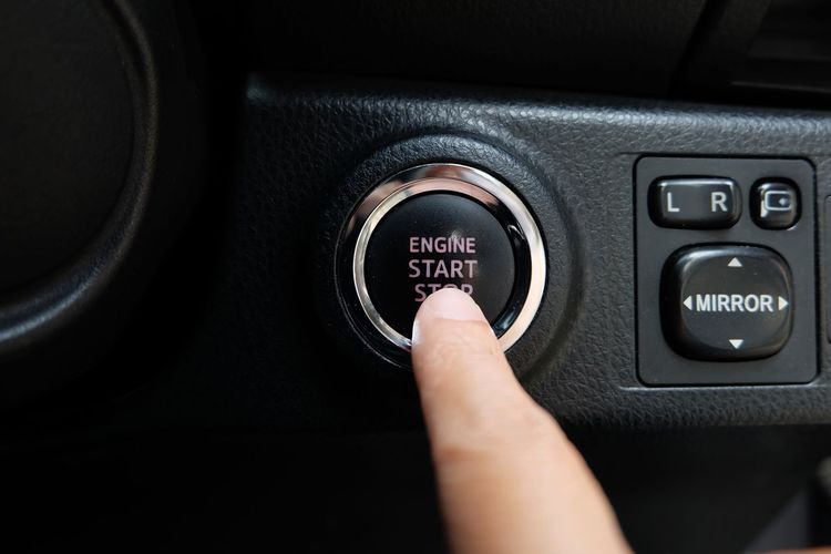 Cropped hand pressing button in car