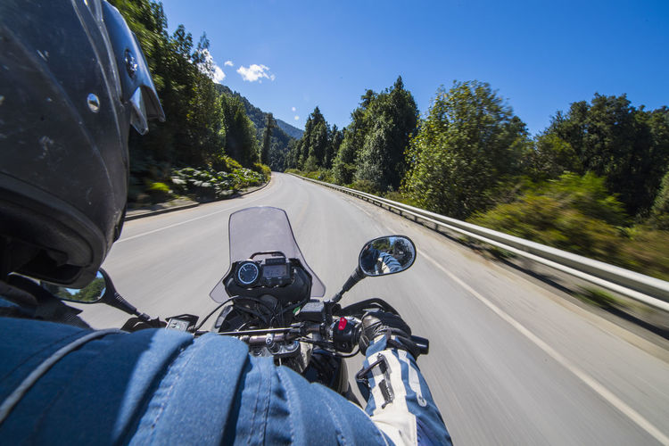 Man driving on a touring motorbike on ruta 7 - the carretera austral