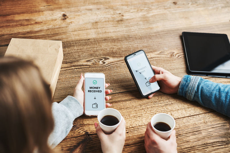 Money transfer. online banking. friends sending and receiving money online using app on smartphones