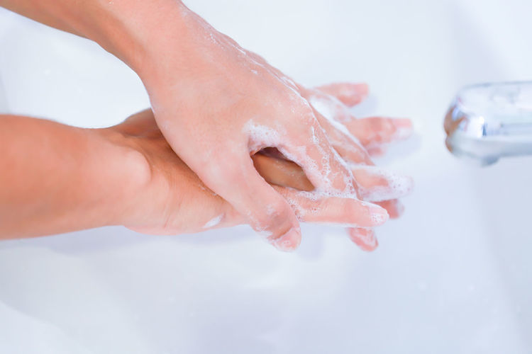 Close-up of person hand showing in bathroom