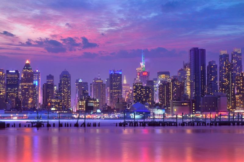 Illuminated cityscape against sky at night